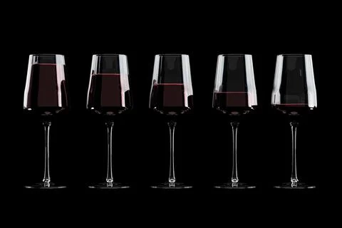 Glasses of wine with different serving size on black background Stock Photos