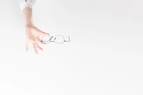 Glasses in your hands on a light background. Banner Foto stock