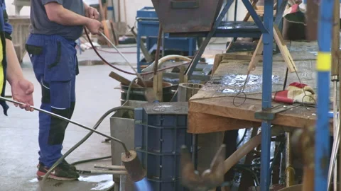 Glassmakers team processes form with gas burners in shop Stock Footage 166062881