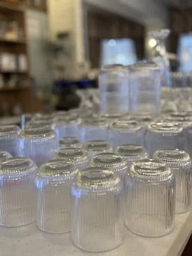 Glassware display in cozy store setting with soft lighting, featuring stack.. Foto stock