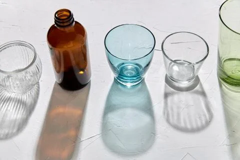 Glassware dropping shadows on white surface Stock Photos