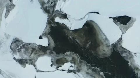 Glassy forest stream splashes while making its way through gorgeous snowy Stock Footage 165347416