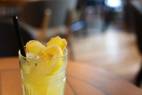 Glassy glass stands on table with drinking straw, which been poured tea Stock Photos