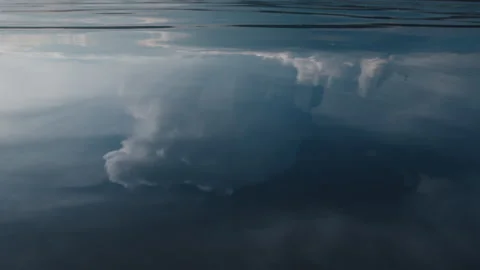 Glassy surface of the river with reflection of the cumulonimbus clouds Stock Footage 338001739