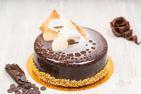 The  glaze cake with chocolate rose on the table Stock Photos