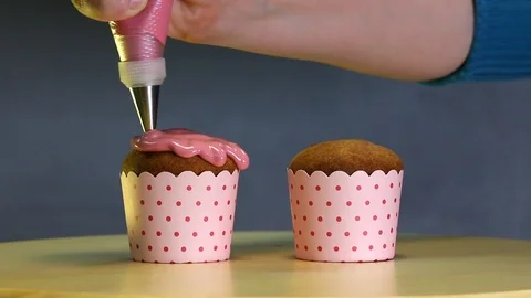 Glaze is flowing down smoothly on the cupcake. Stock Footage 90333853
