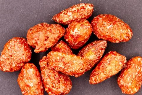 Glazed caramelized almonds with sugar coating as snack food Stock Photos