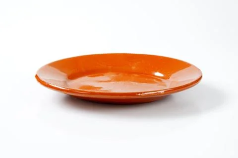 Glazed ceramic plate on white background Stock Photos