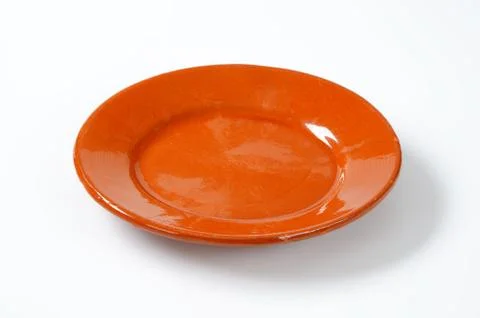 Glazed ceramic plate on white background Stock Photos