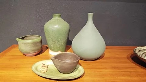 Glazed ceramic vases on wooden table. Stock Footage 339988875