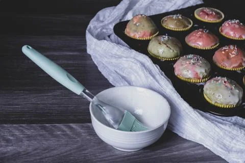 Glazed cupcakes stand on the table. Stock Photos