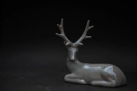 Glazed deer statue on black background Stock Photos