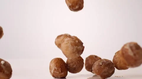 Glazed donut holes bouncing on white slow motion macro food studio 4K stock Stock Footage 336706969