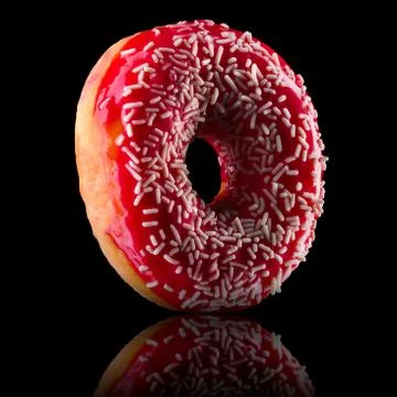 Glazed donut with reflection on a black background rotated in three quarters Stock Photos