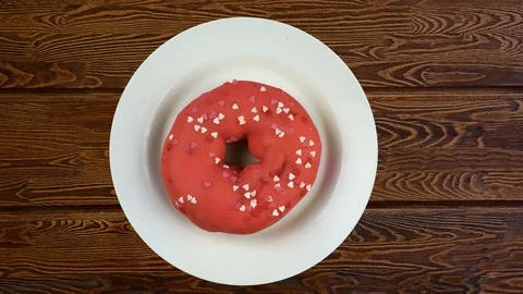 Glazed donut on the wooden table. Stop motion disappearing. 스톡 동영상 109091001