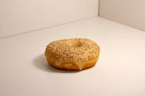 Glazed doughnut on a white surface. Stock Photos