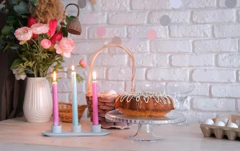 Glazed Easter cake and candles on kitchen counter decorated for Easter Stockfoto's