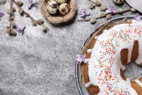 Glazed Easter cake with sprinkles and quail eggs on grey table, flat lay. Spa Stock Photos