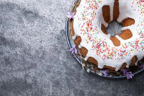 Glazed Easter cake with sprinkles on grey table, top view. Space for text Stock Photos
