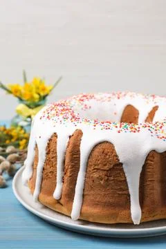 Glazed Easter cake with sprinkles on light blue wooden table, closeup Stock Photos