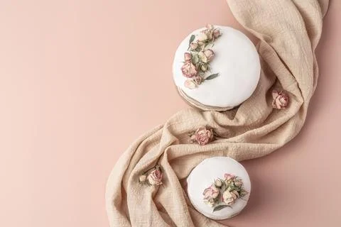 Glazed Easter cakes decorated with dry tea rose flowers on pastel background Stock Photos