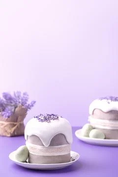 Glazed Easter cakes decorated with lavander flowers and chocolate eggs on bright Stock Photos