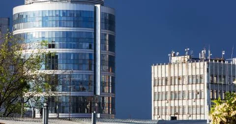 The glazed facade of an office building with reflected sky Stock Photos