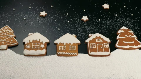 Glazed gingerbread in the shape of Christmas trees and huts, on a black Stock Footage 257018804