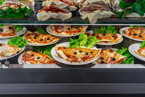 Glazed showcase inside a cafe with fresh Italian dishes and herbs in Milan, n Stock Photos