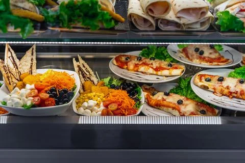 Glazed showcase inside a cafe with fresh Italian dishes and herbs in Milan, n Stock Photos