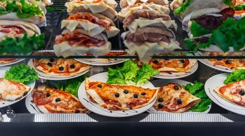 Glazed showcase inside a cafe with fresh Italian dishes and herbs in Milan, n Stock Photos