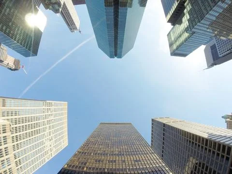 Glazed skyscraper from below with wide angle and blue sky Stock Photos