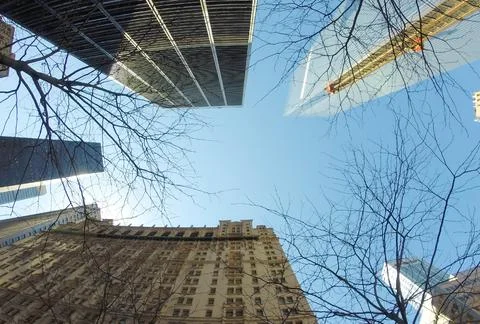 Glazed skyscraper from below with wide angle and blue sky Stock Photos