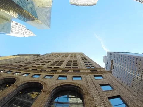 Glazed skyscraper from below with wide angle and blue sky Stock Photos