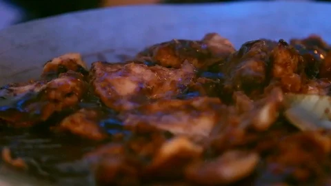 Glazed steaming chicken with serving spoon closeup 動画素材 91104675