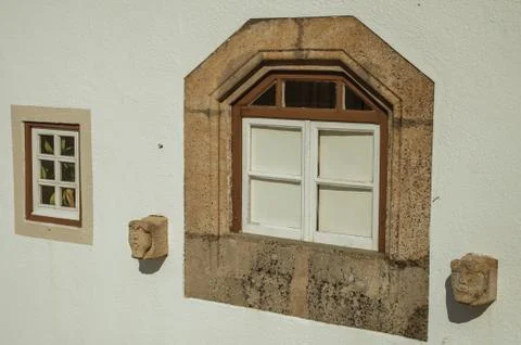 Glazed window with decorative stone frame in Marvao Stock Photos