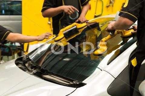 Glazier is repairing windshield of the car Stock Photos