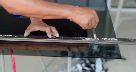 Glazier uses a machine to cut glass with high sharpness. Stock Footage 238892018
