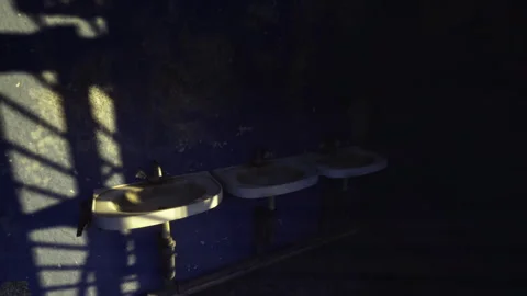 Gleaming rays enter abandoned toilet room creating stark silhouettes Stock Footage 341830489