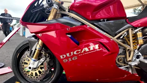 Gleaming red Ducati 916 on display at the Isle of Man TT, showcasing its iconic Stock Footage 316365152