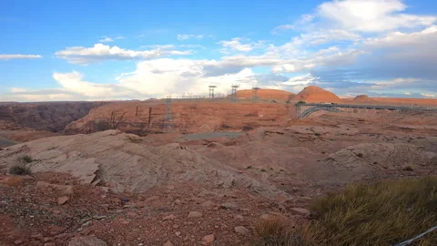 Glen Canyon Bridge over a red rock canyon with power lines under a blue sky-29 Stock-Footage 346102941