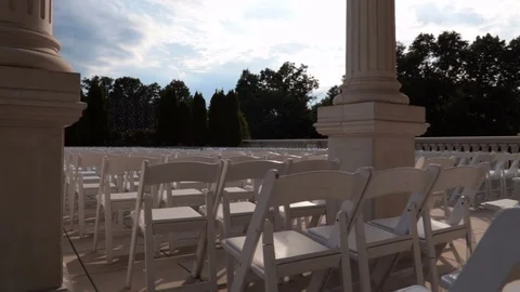 Glide over white chairs through pillars blue sky Stock Footage 91936447