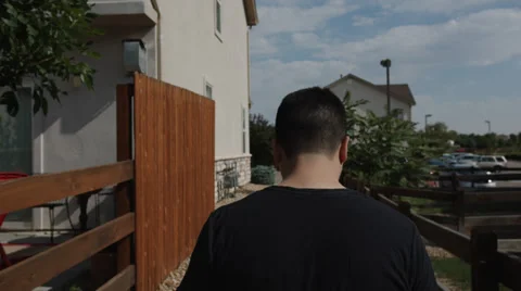 Glidecam Man Walking Between Houses Stock Footage 34403141