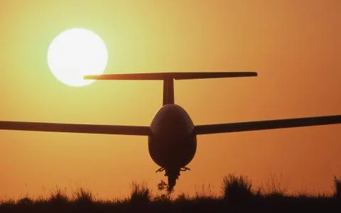 Glider and setting sun Stock Photos