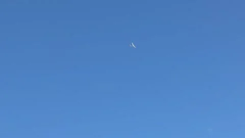 Glider flying high in clear blue sky above Vajolet towers, Dolomites. Italy Stock Footage 336657919