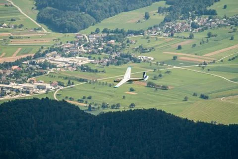 Glider flying over forest Stock Photos