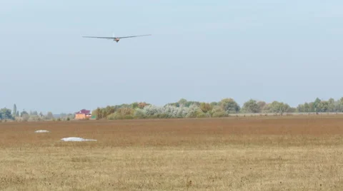 Glider  land on  soil field.  Stockbeeldmateriaal 56135890