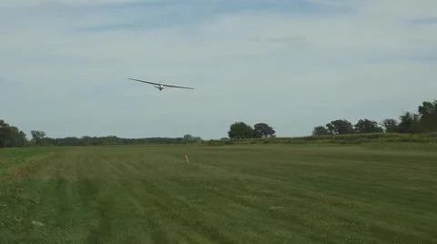 Glider landing on a grass runway Stock Footage 54559125