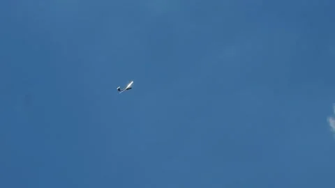 A glider makes a circle in the blue sky Stock Footage 306292740