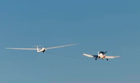 Glider pulled by motor aircraft. Stock Photos